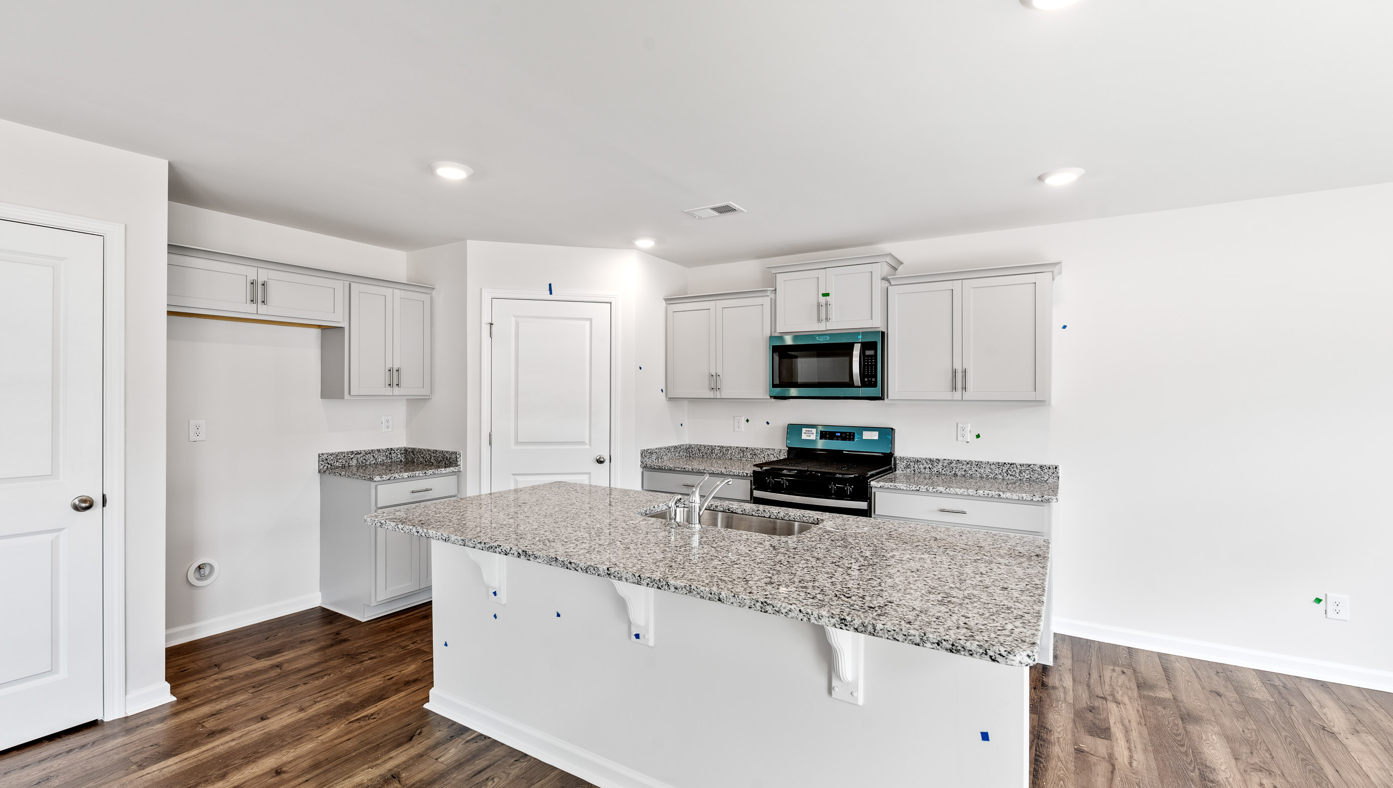 Kitchen and island with granite counter tops.