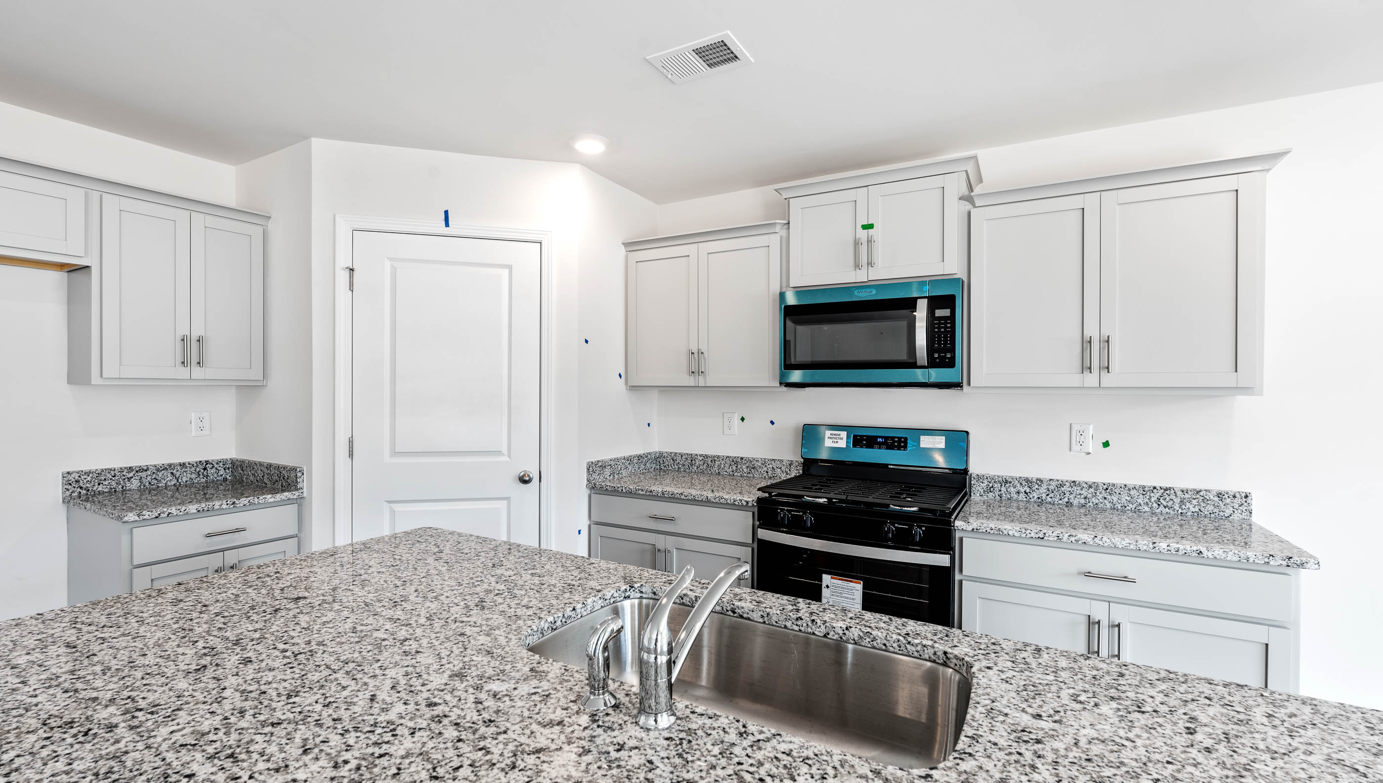Kitchen and island with granite counter tops.