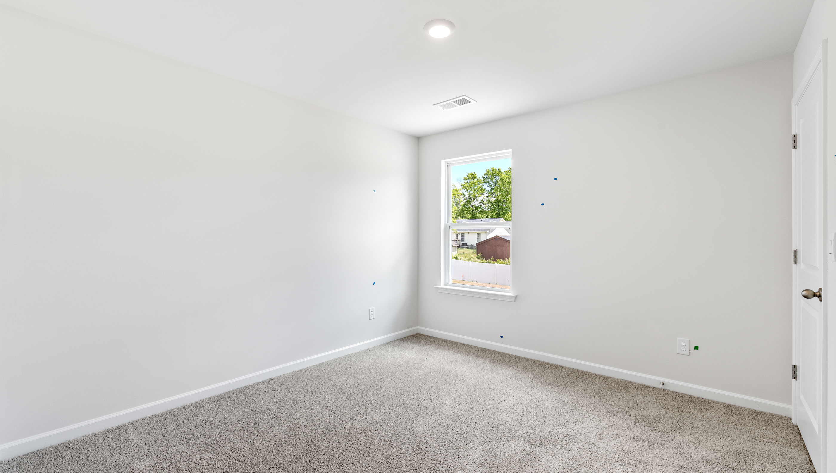 Bedroom with carpet and window.