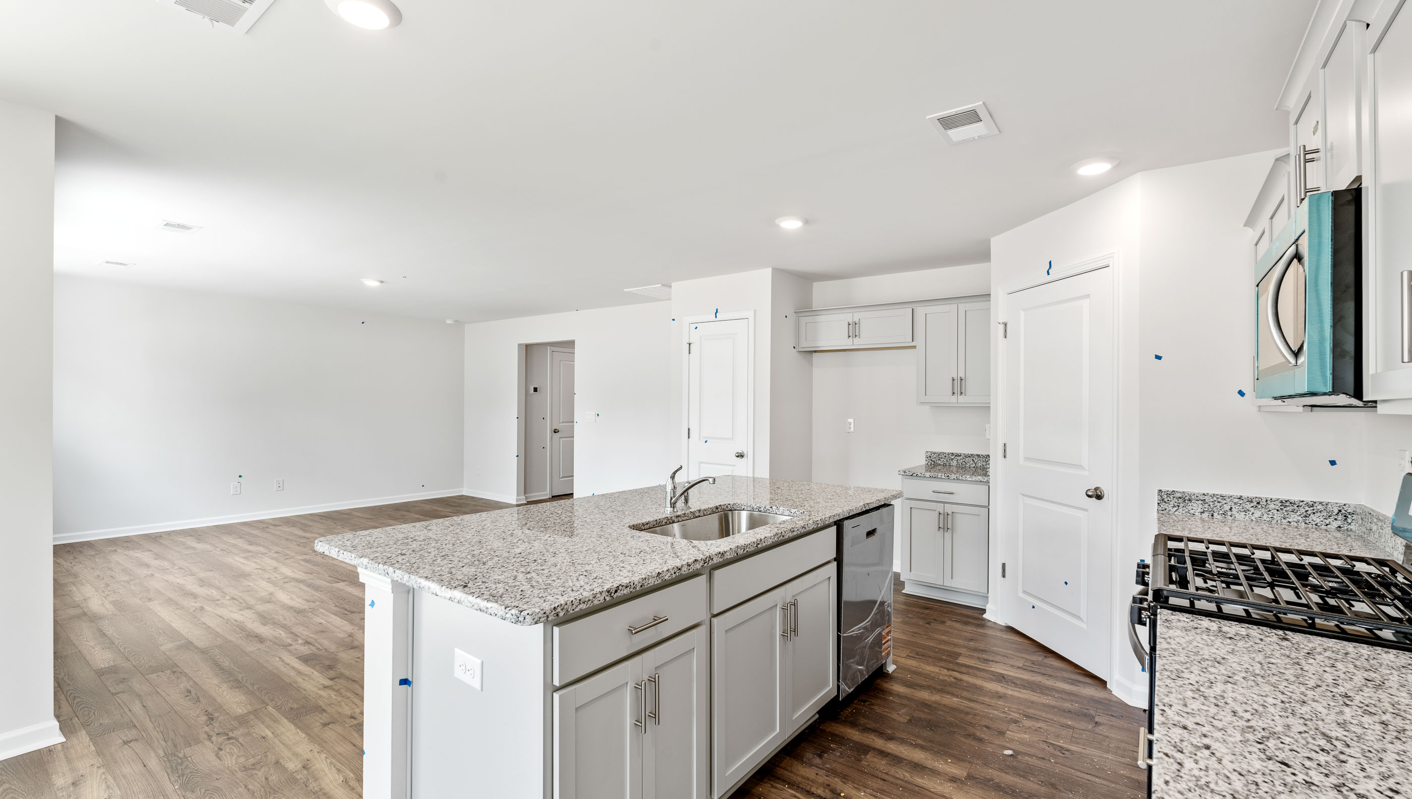Kitchen and island with granite counter tops.