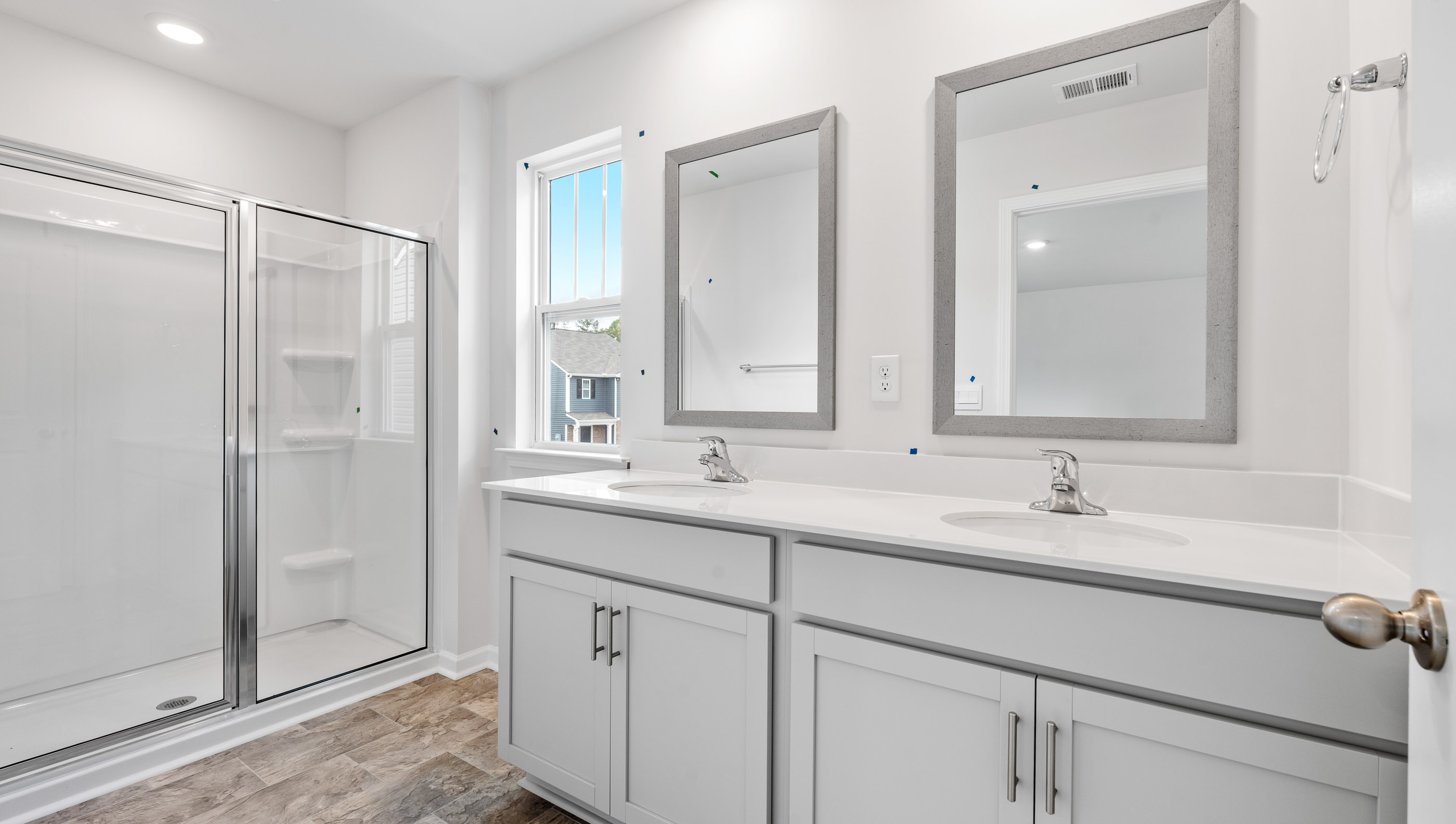 Bathroom with double sink vanity and walk in shower.