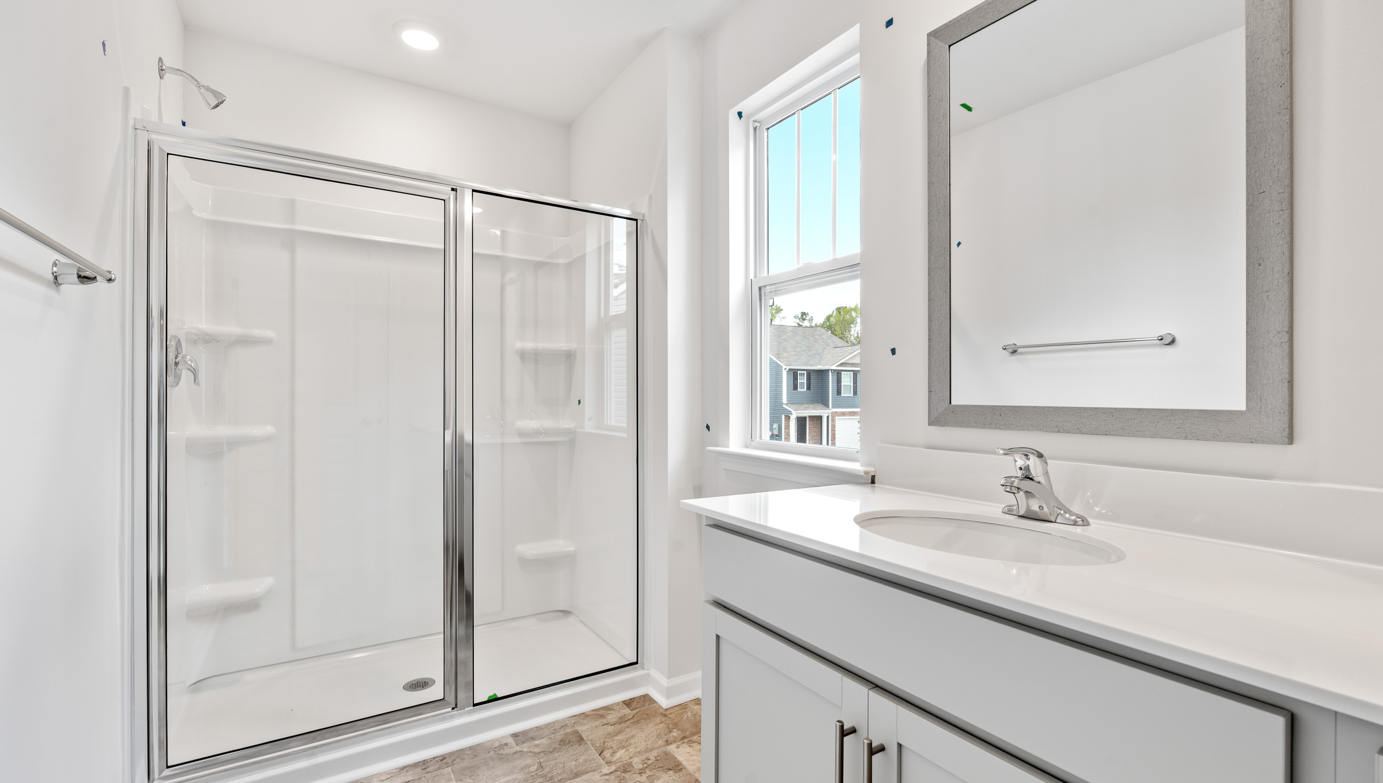 Bathroom with double sink vanity and walk in shower.