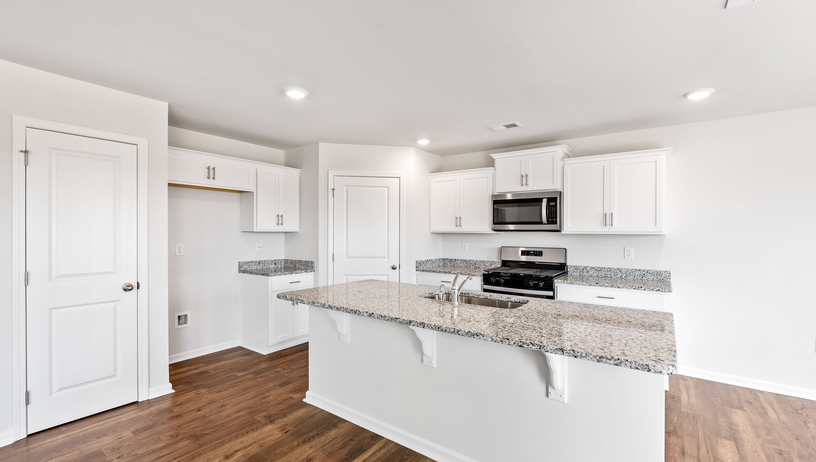 Kitchen and island with granite countertops.