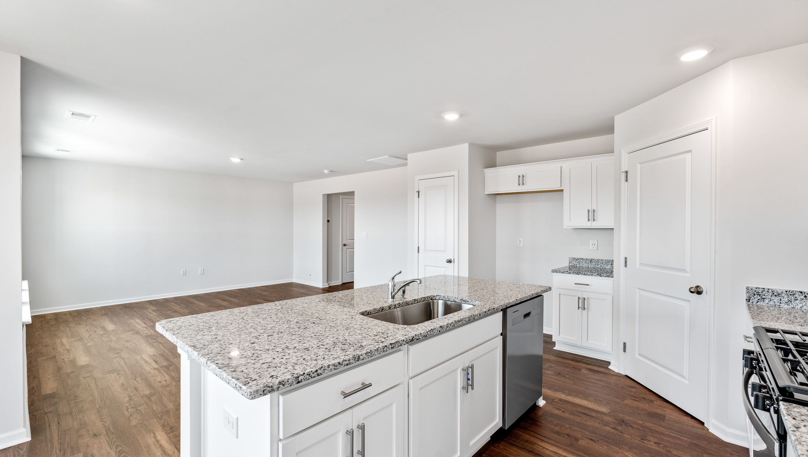 Kitchen and island with granite countertops.