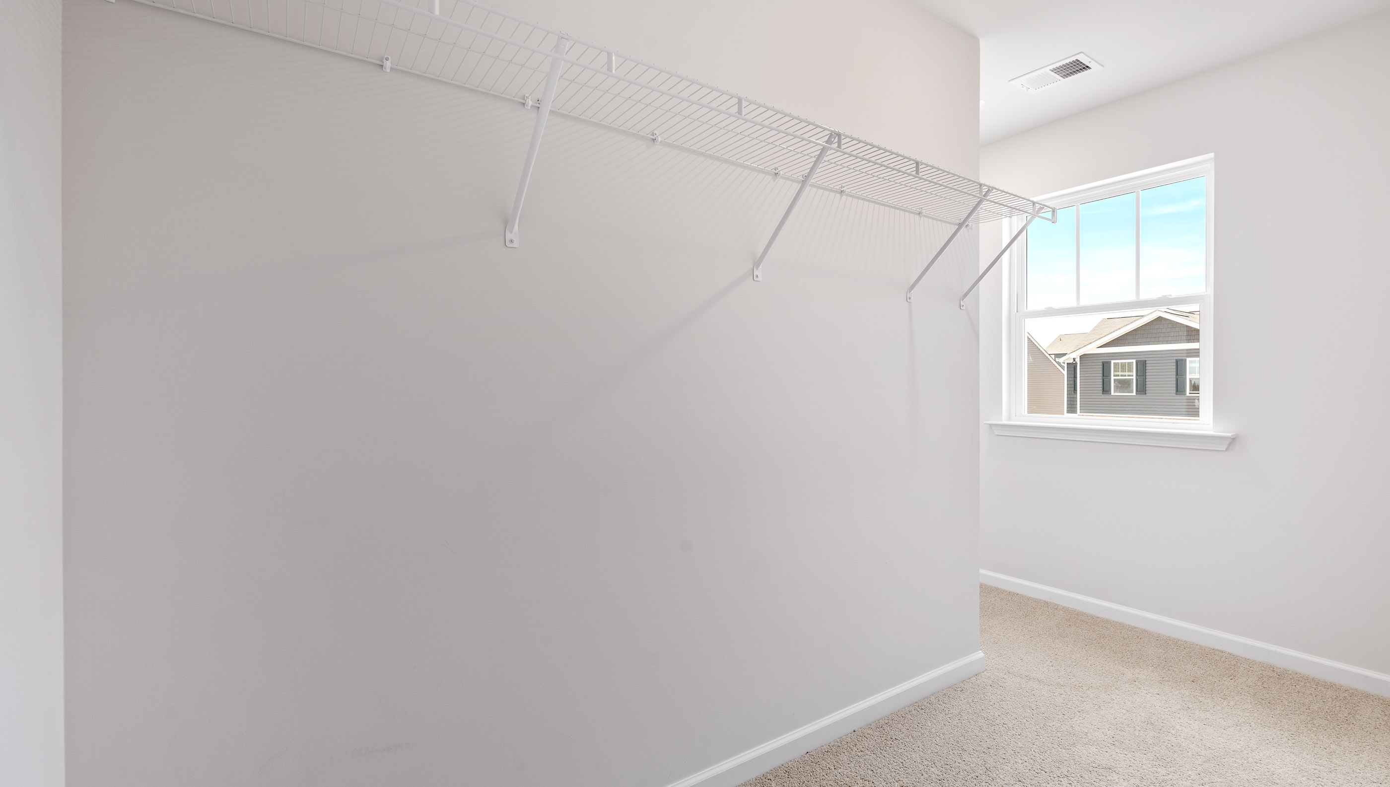 Walk in closet with shelves.