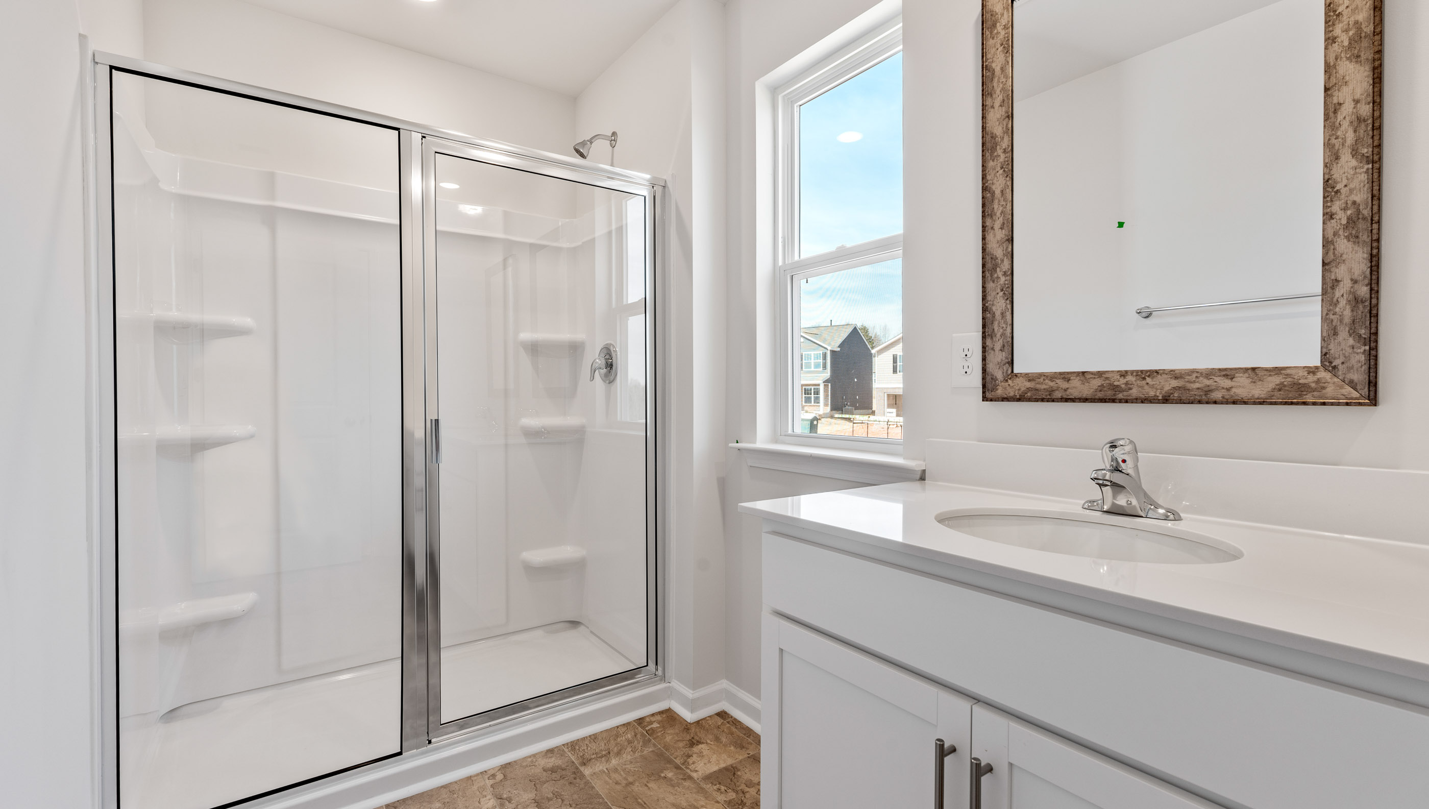 Bathroom with vanity and walk in shower.