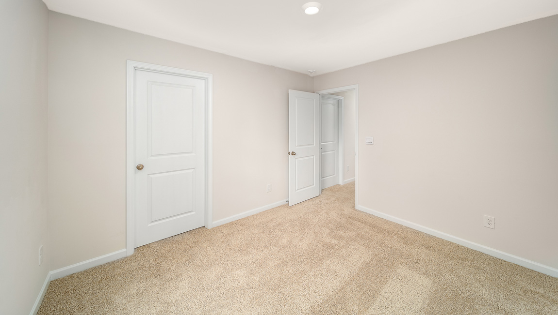 Carpeted bedroom with window