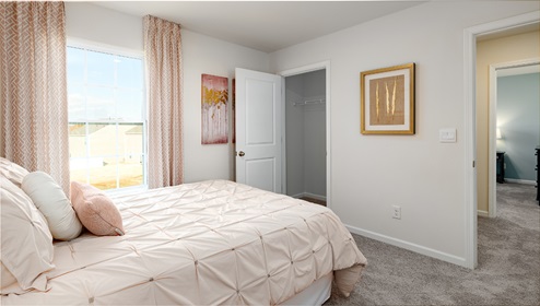 Carpeted bedroom with small window