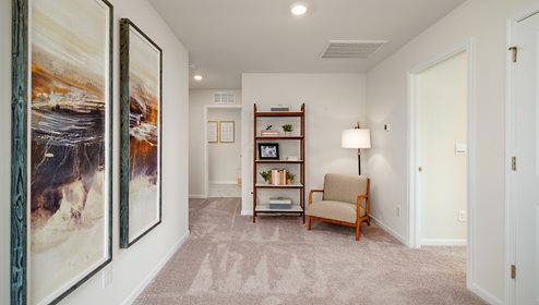 Carpeted loft space with small window