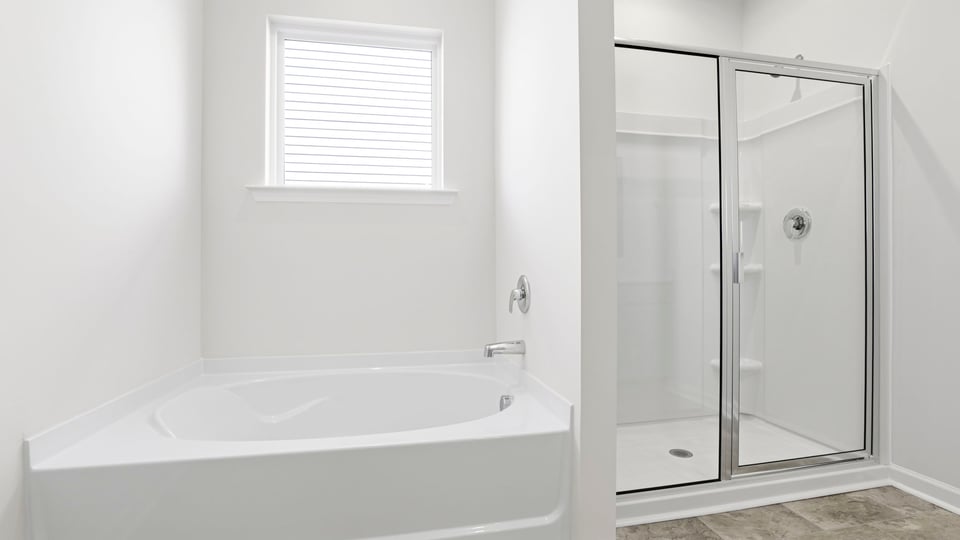 Bathroom with tub and walk in shower.