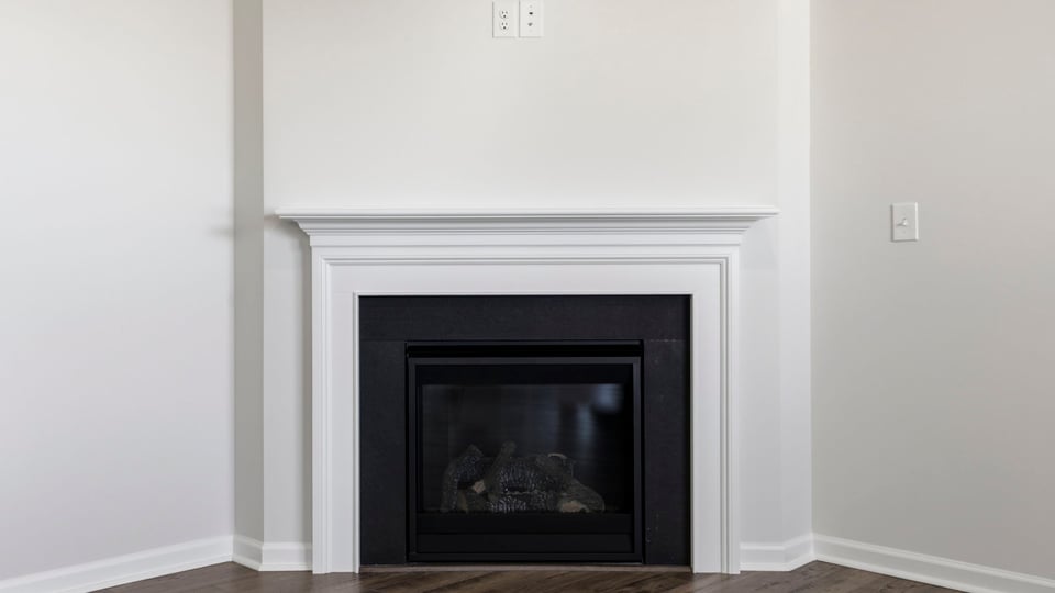 Livingroom with fireplace with window.