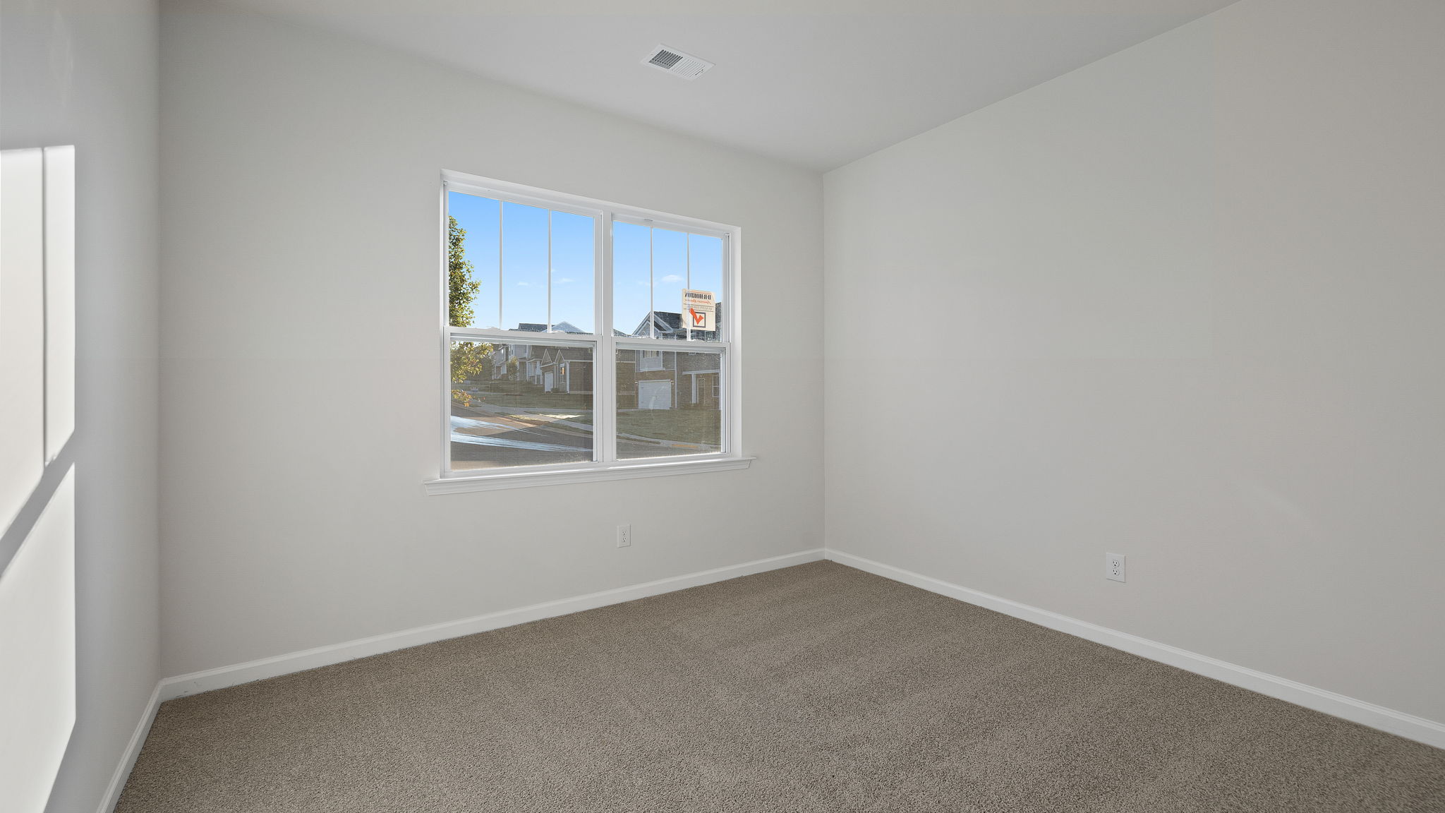 Bedroom with carpet and windows.