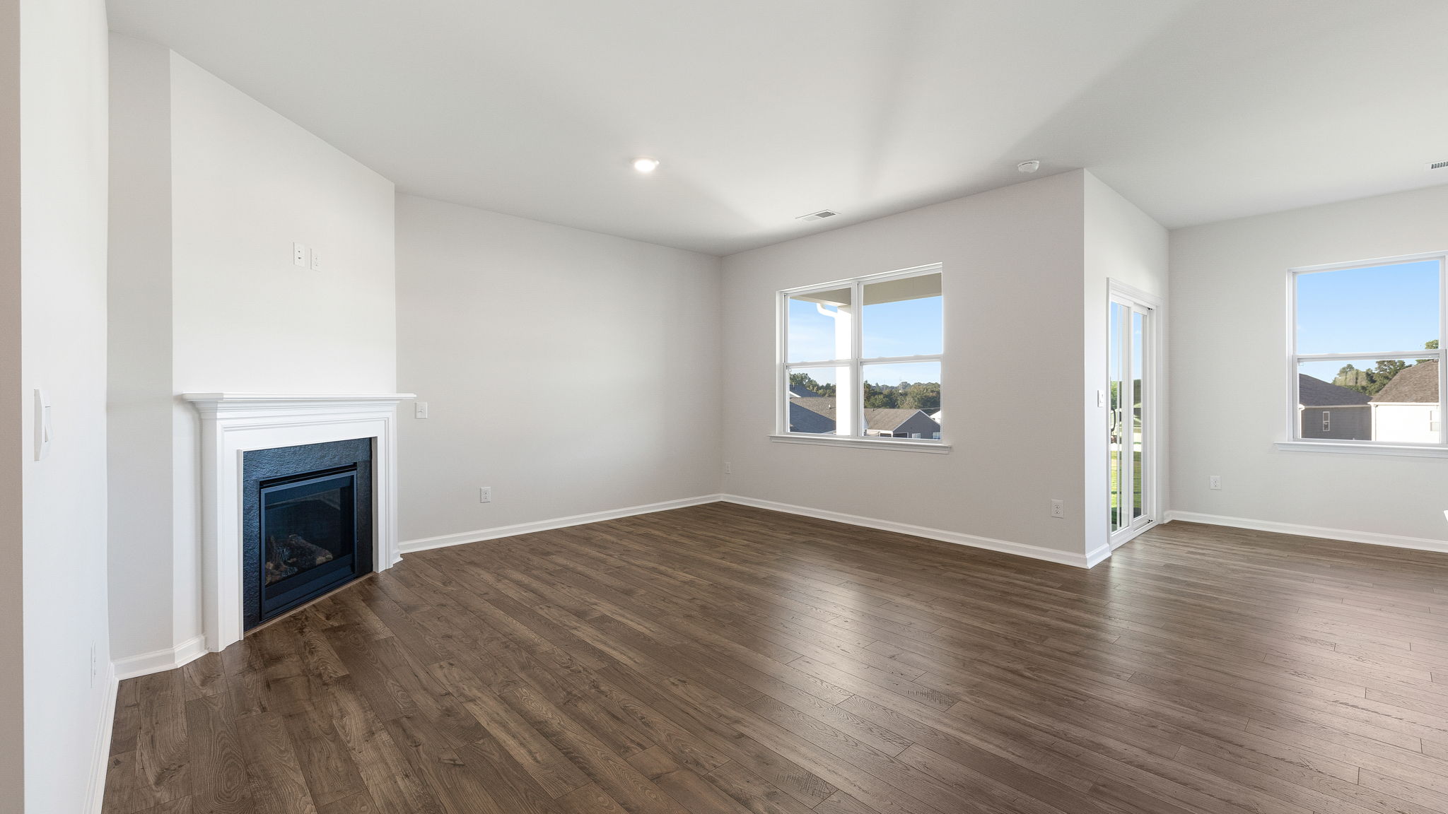 Living room with fireplace and windows.