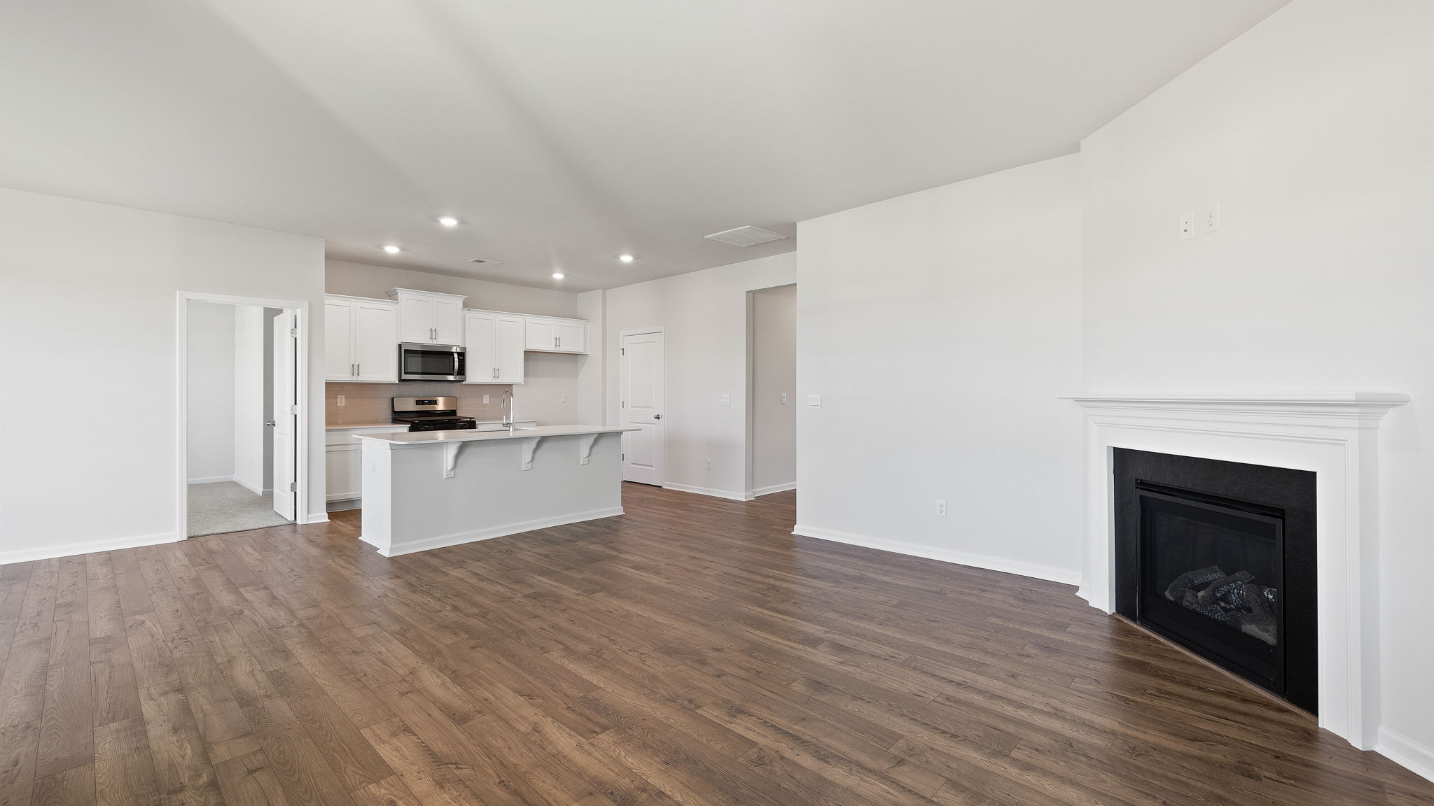 Living room with fireplace facing kitchen.