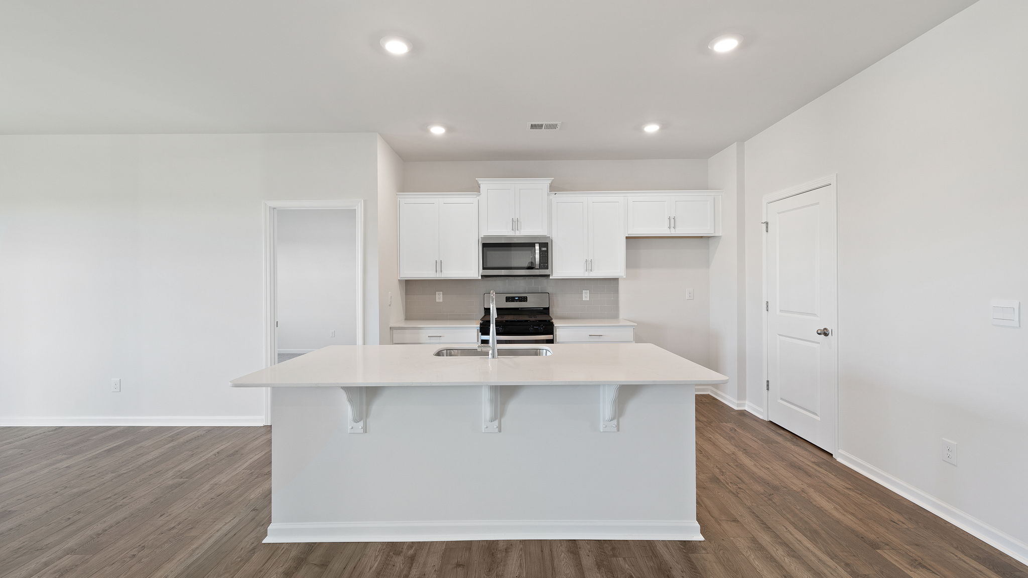 Kitchen and island with granite countertops.