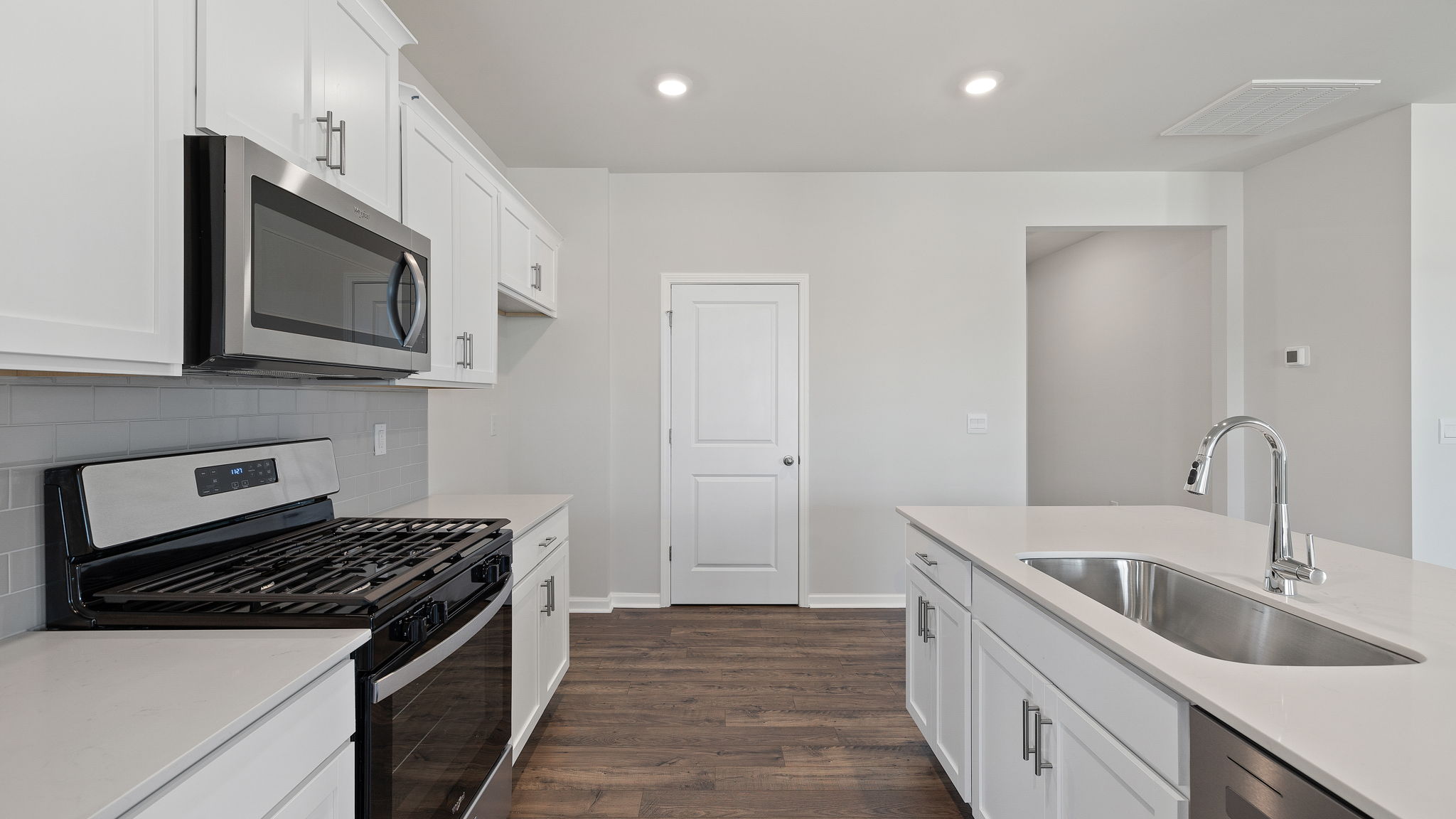 Kitchen and island with granite countertops.