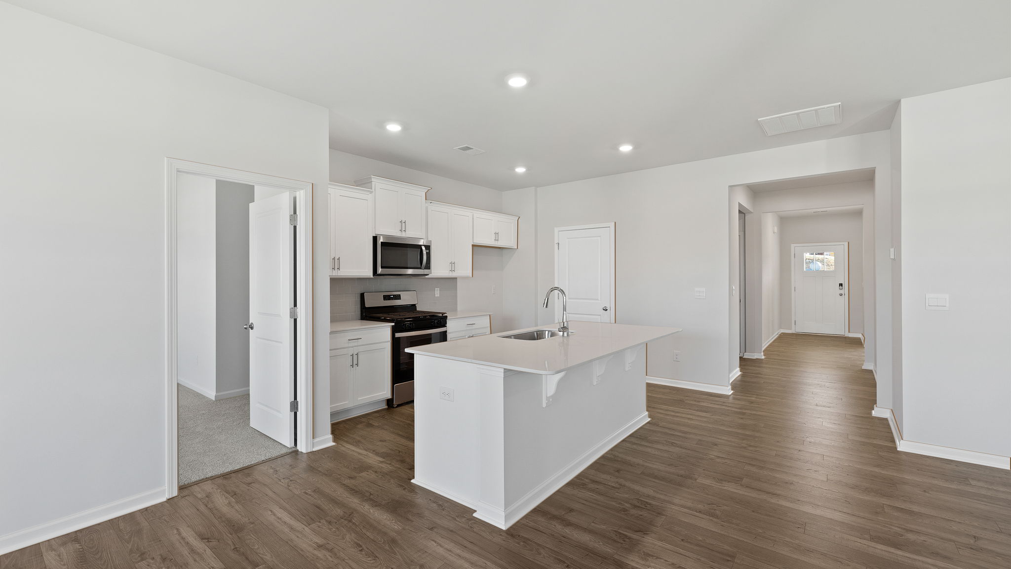 Kitchen and island with granite countertops.