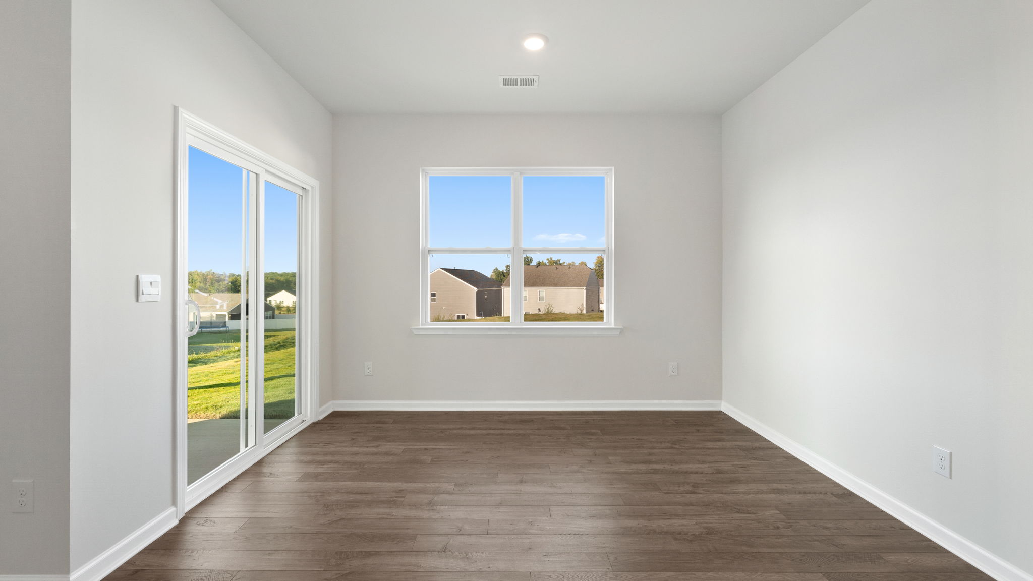Dining room with windows and sliding doors.