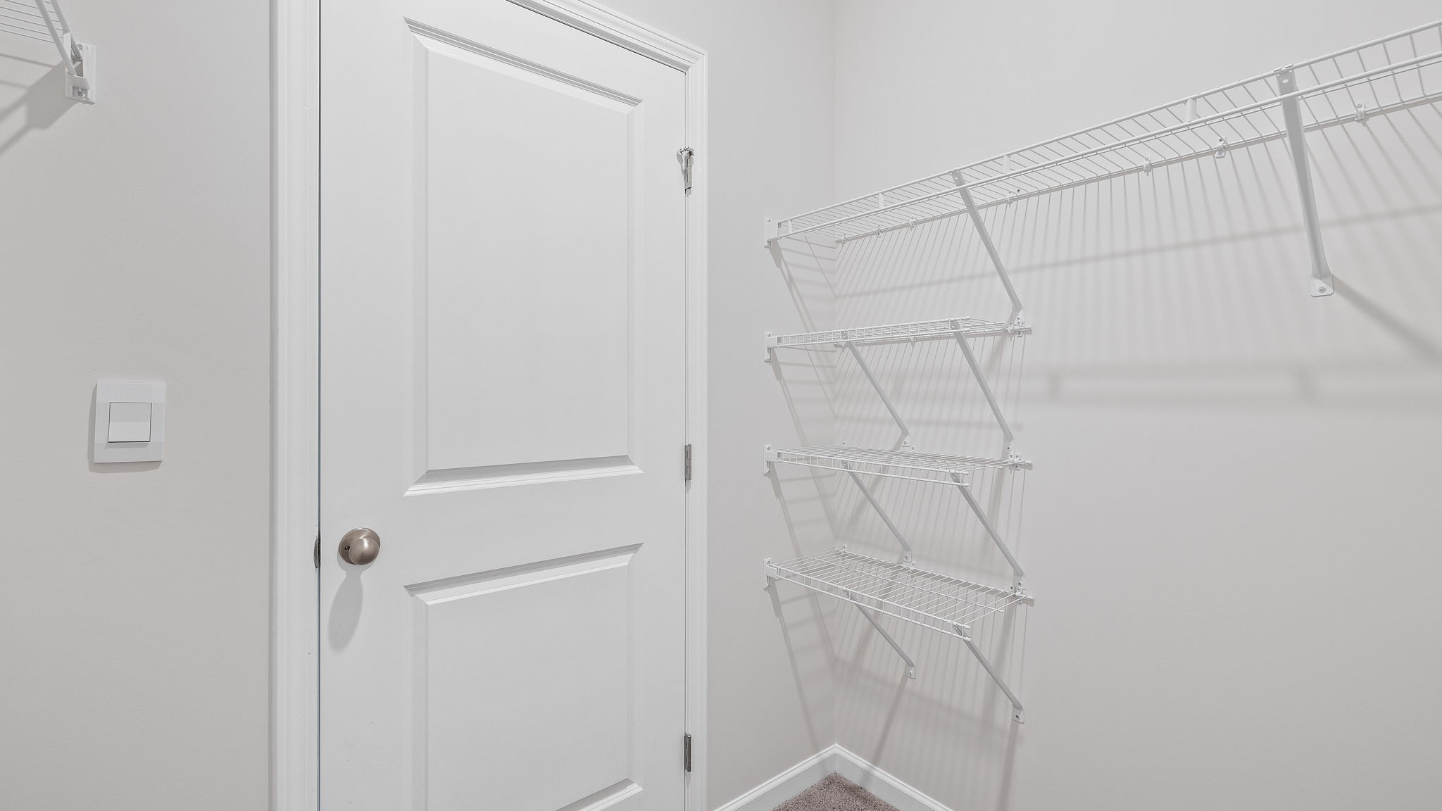Walk in closet with shelves.