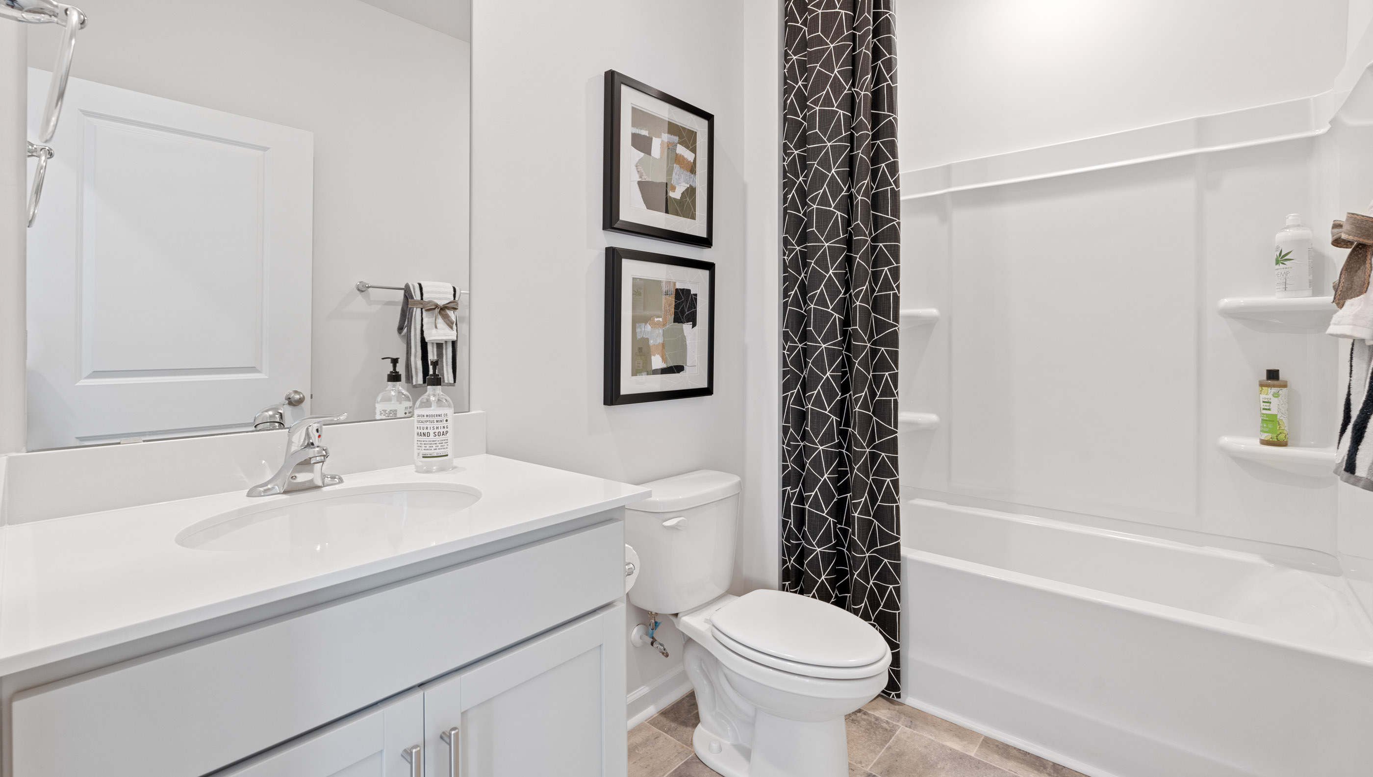 Bathroom with single vanity sink and bathtub.