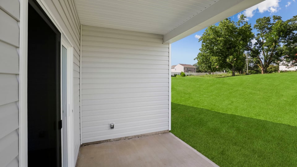 Back exterior of home with patio.