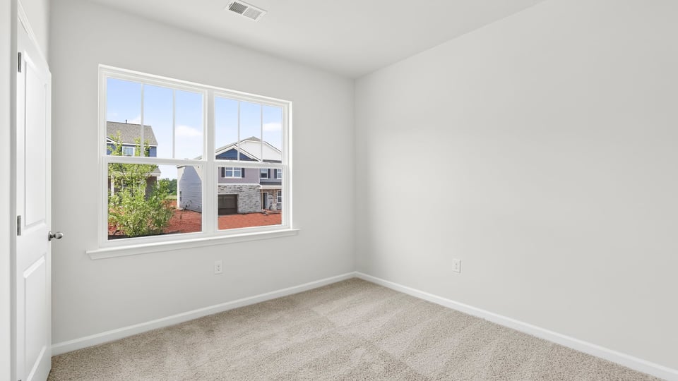 Bedroom with carpet and window.