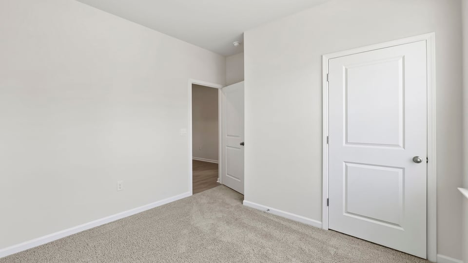 Bedroom with carpet and window.