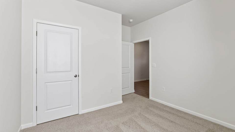 Bedroom with carpet and window.