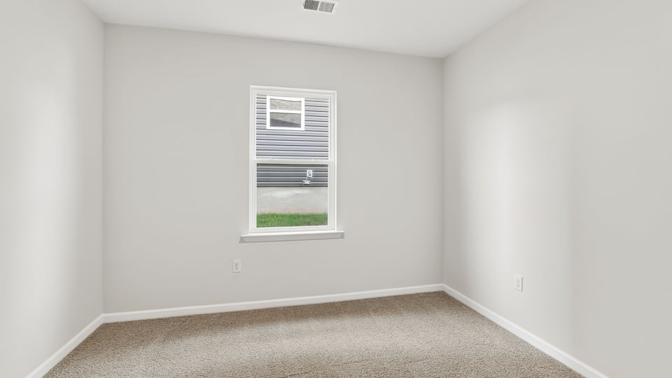 Bedroom with carpet and window.