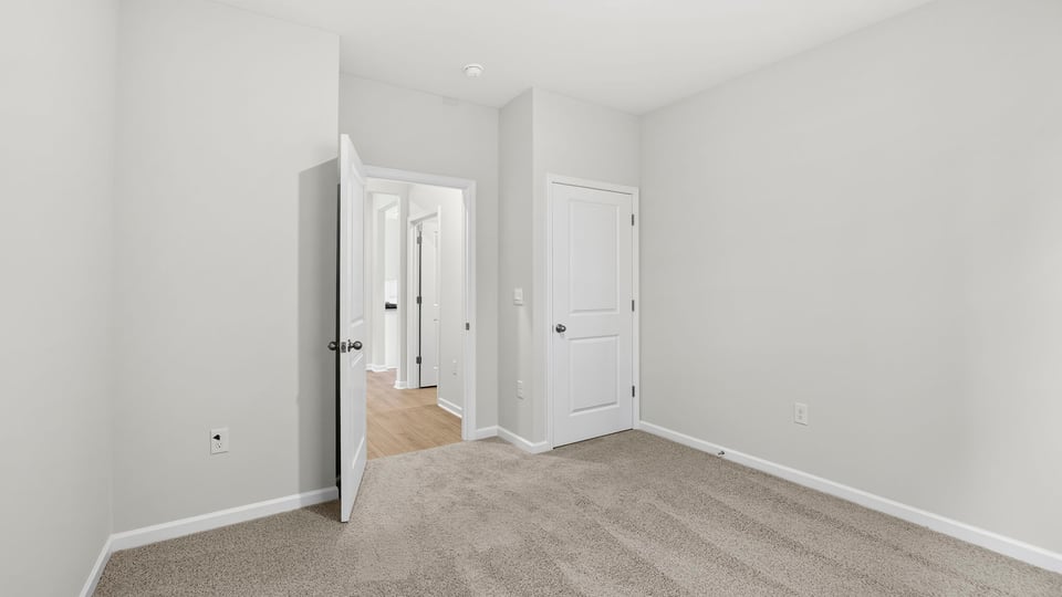 Bedroom with carpet and window.