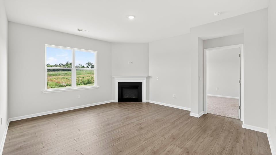 Livingroom with fireplace and window.
