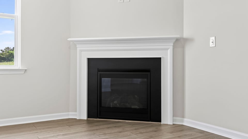 Livingroom with fireplace and window.