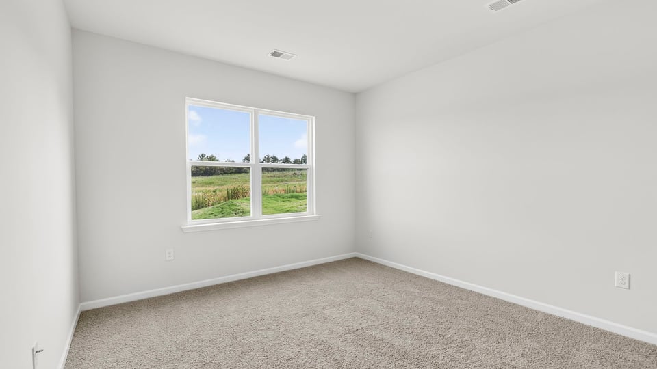 Bedroom with carpet and window.