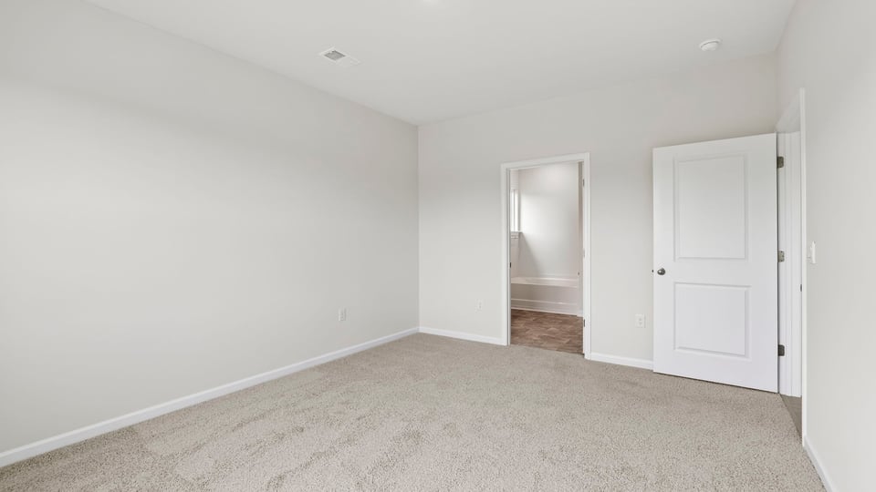 Bedroom with carpet and window.