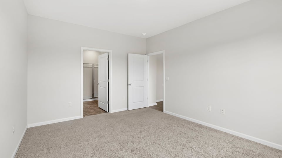 Bedroom with carpet and window.