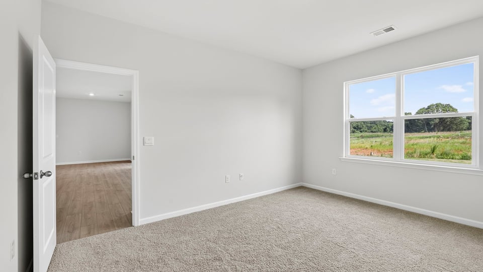 Bedroom with carpet and window.
