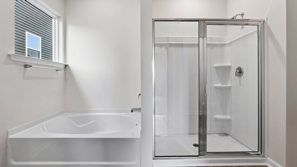 Bathroom with tub and walk in shower.