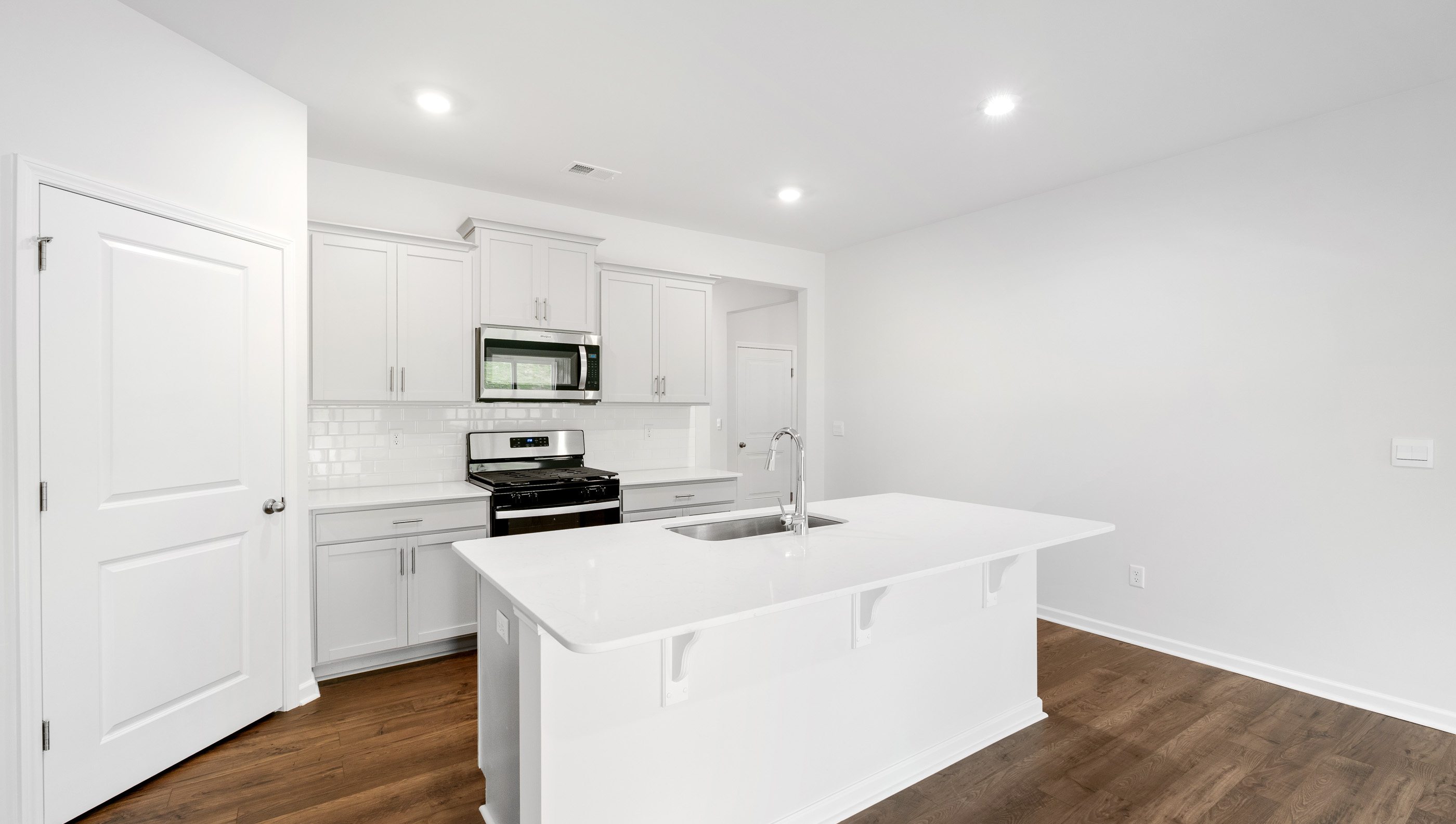 Kitchen with island and granite countertops.