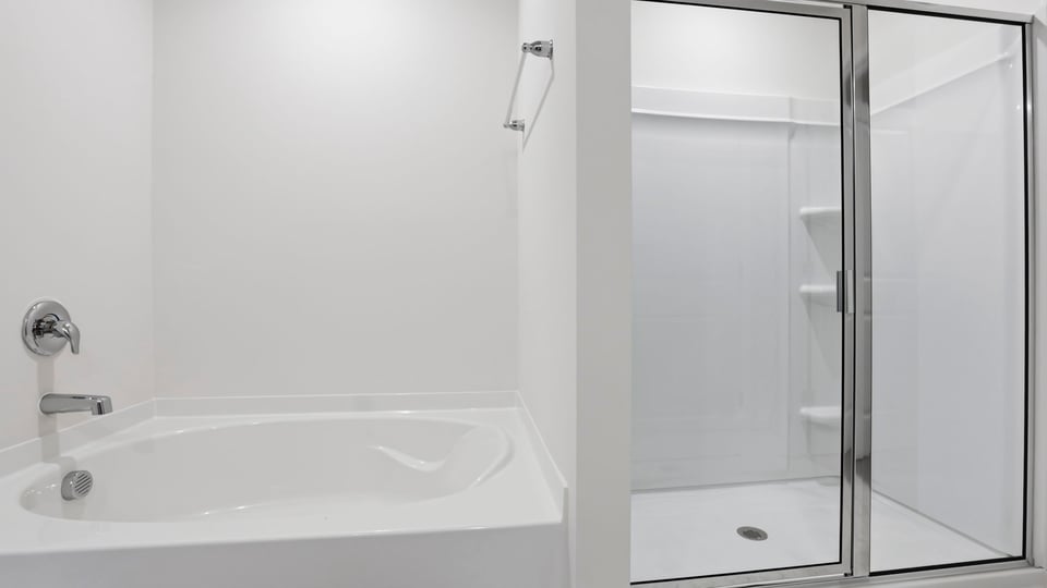 Bathroom with tub and walk in shower.