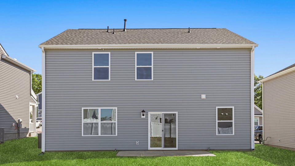 Exterior of home with large backyard.