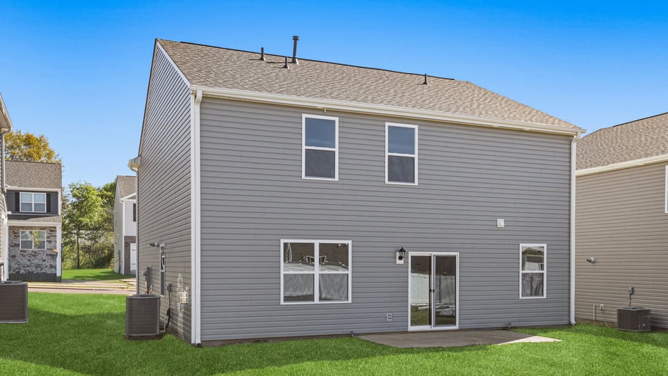 Exterior of home with large backyard.
