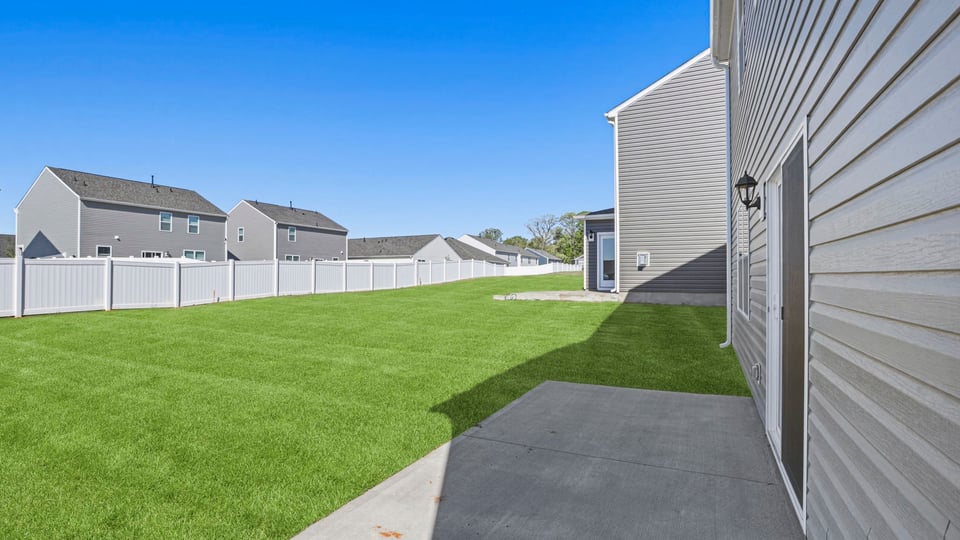 Exterior of home with large backyard.