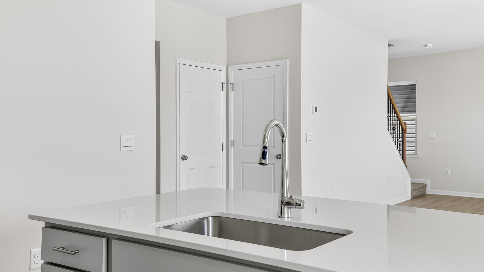 Kitchen with quartz countertops and stainless steel appliances.
