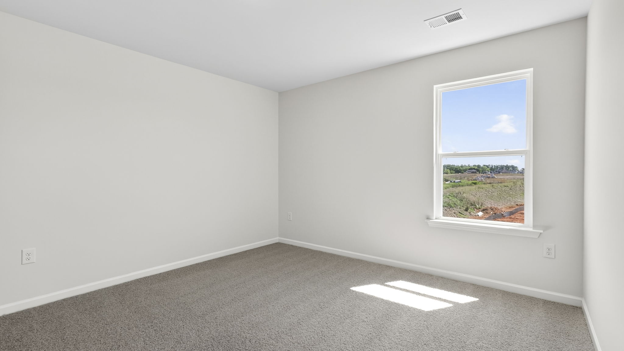 Bedroom with carpet and window.
