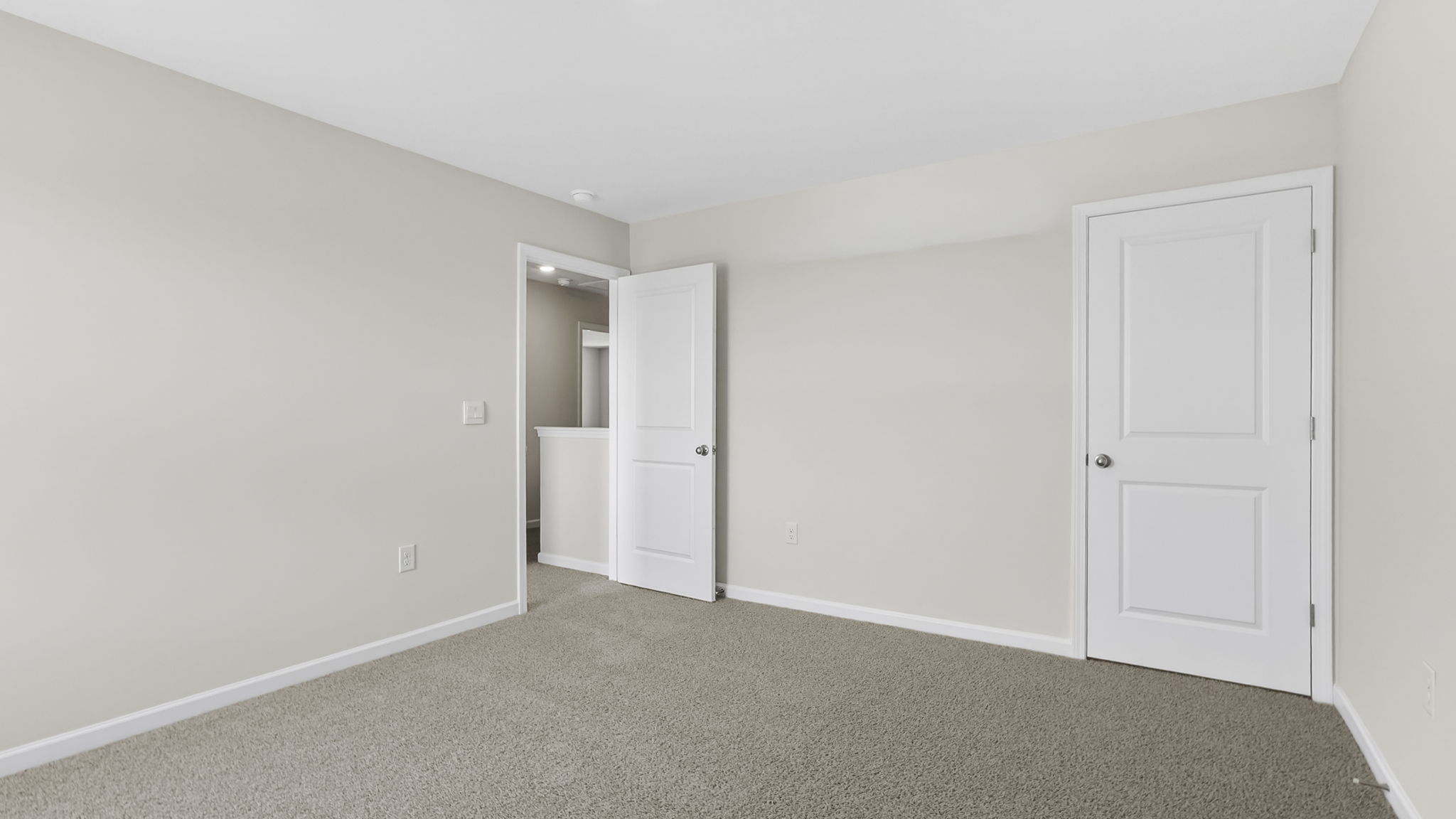 Bedroom with carpet and window.