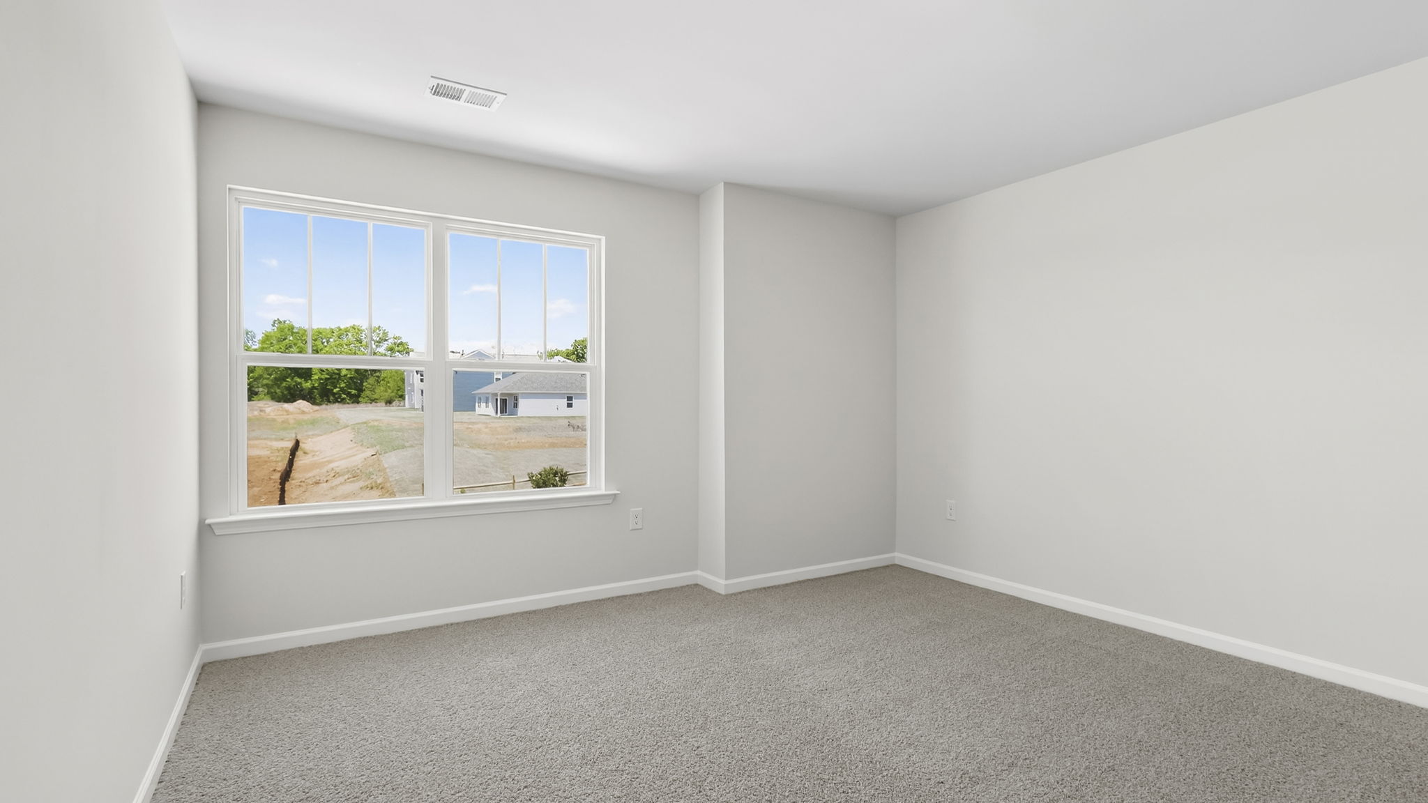 Bedroom with carpet and window.