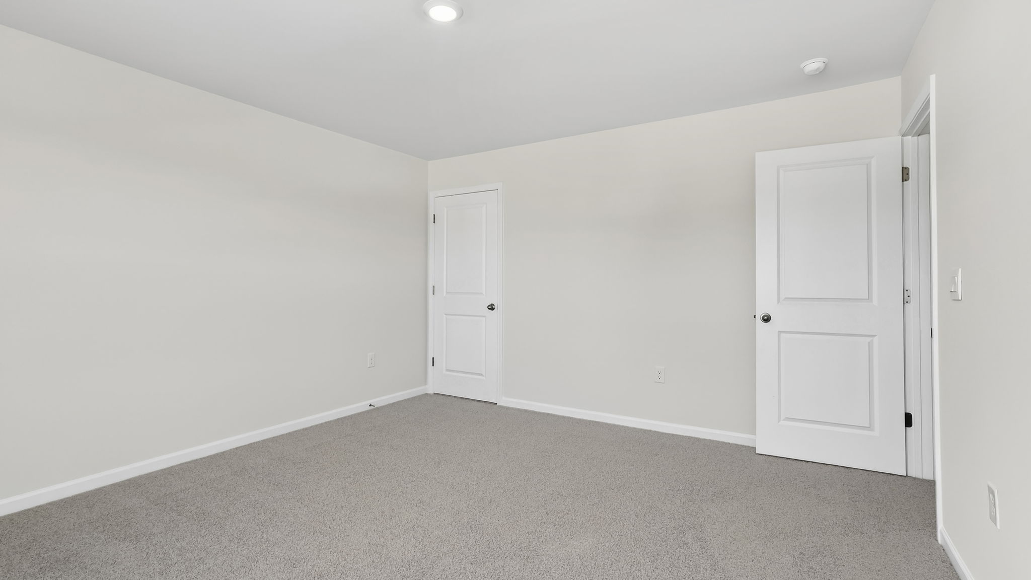 Bedroom with carpet and window.