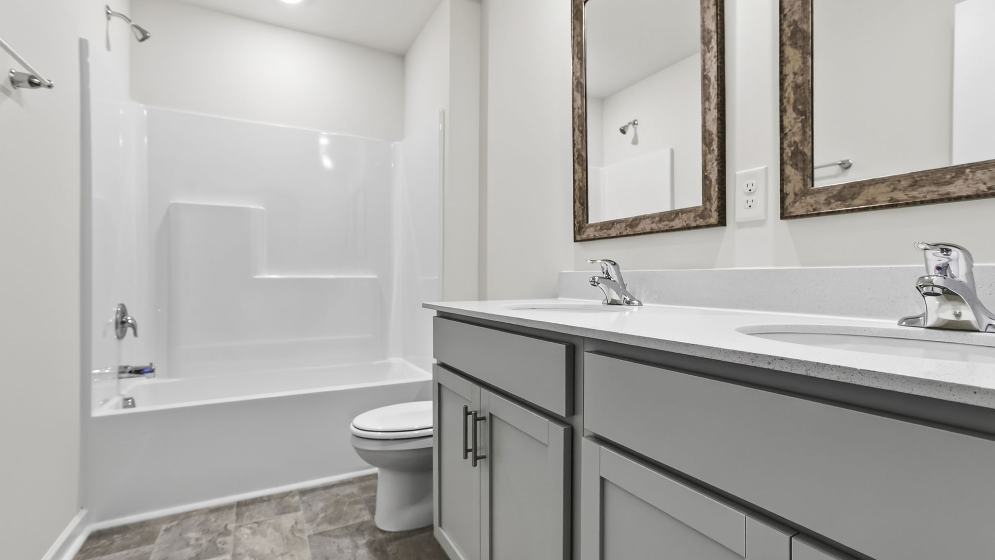 Bathroom with double vanity sink and tub.