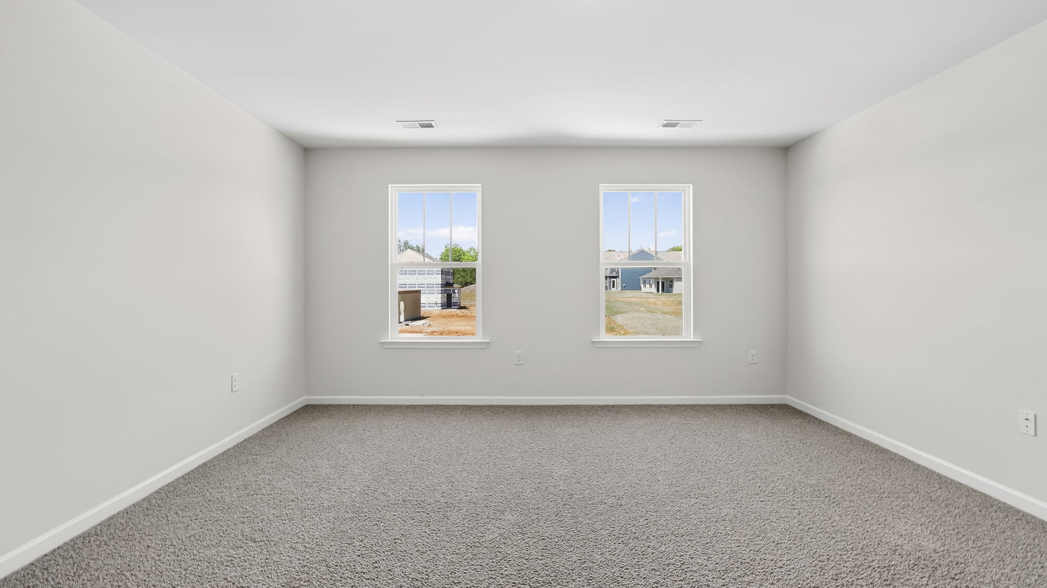 Bedroom with carpet and window.