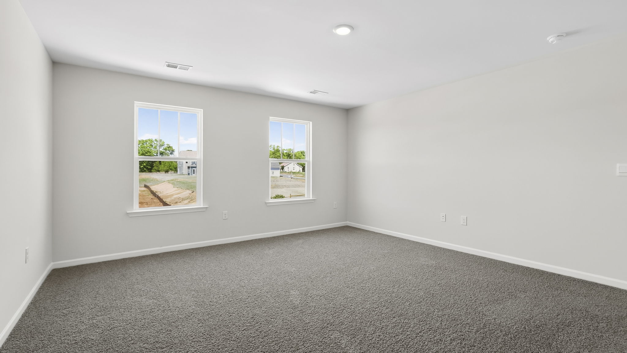 Bedroom with carpet and window.